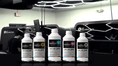 Load image into Gallery viewer, DTF Supply ink bottles on the Imperial Custom Apparel production floor
